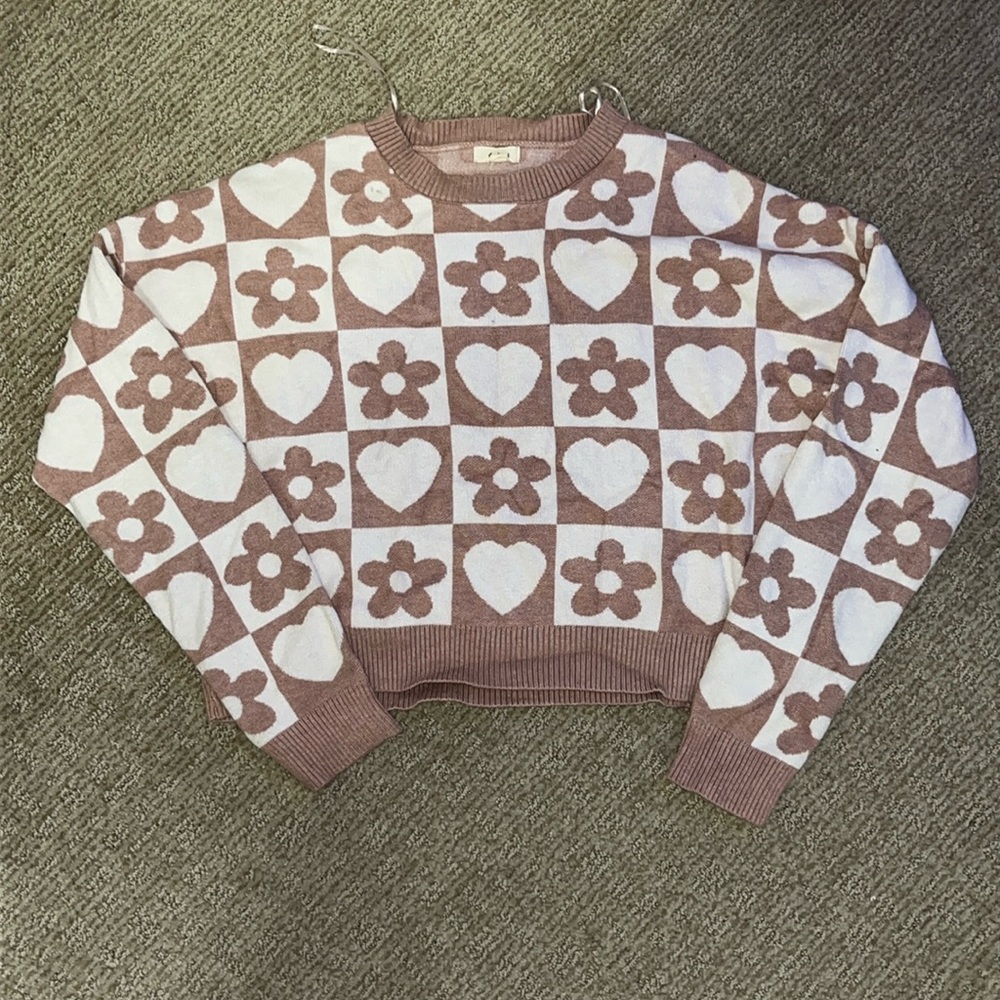 Checkered pink and white sweater.